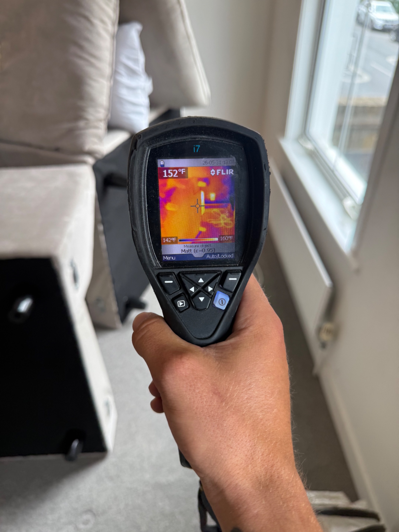 FLIR thermal reading 152°F on a sofa