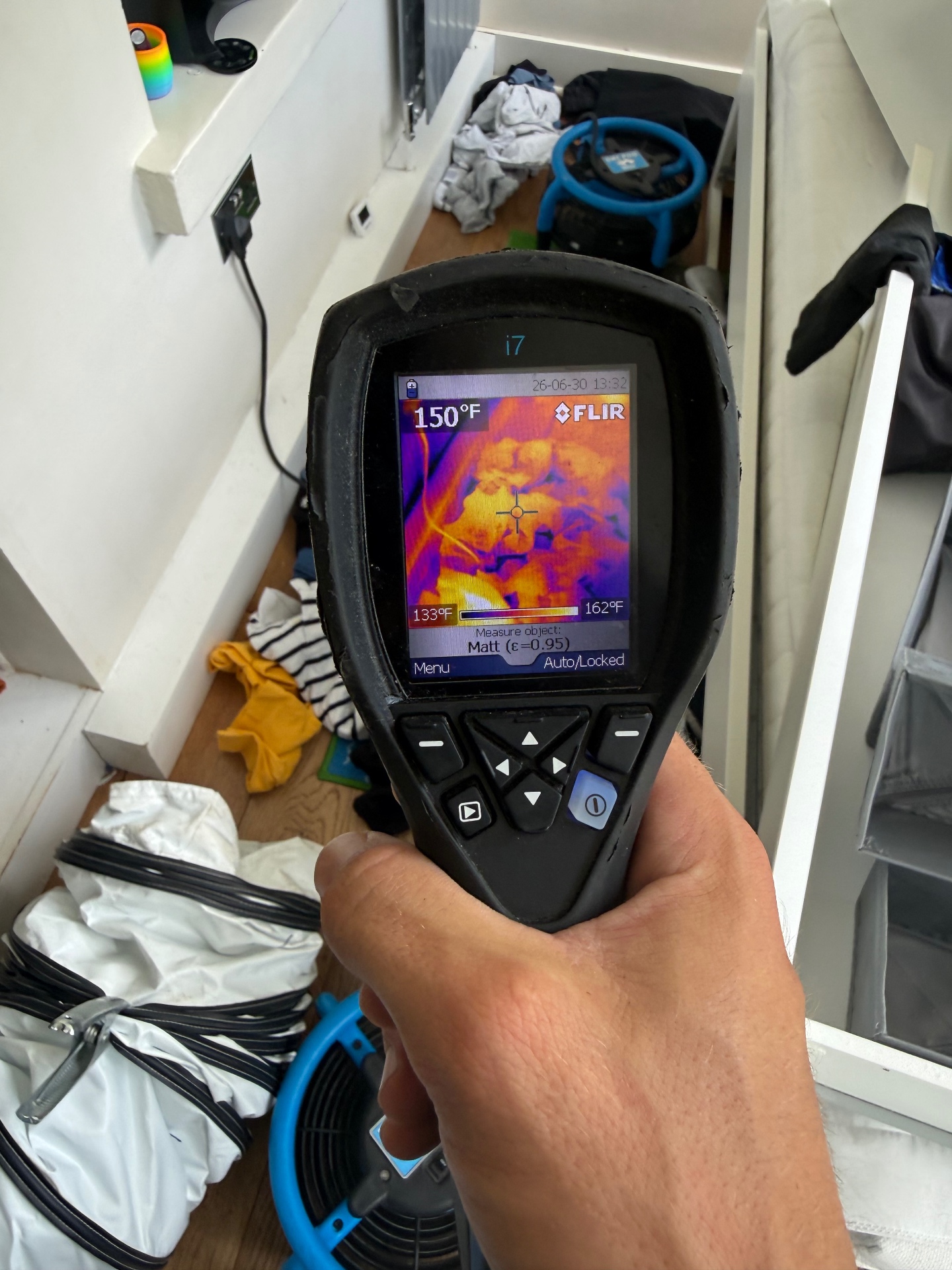 FLIR thermal reading 150°F under-stairs cupboard during heat treatment