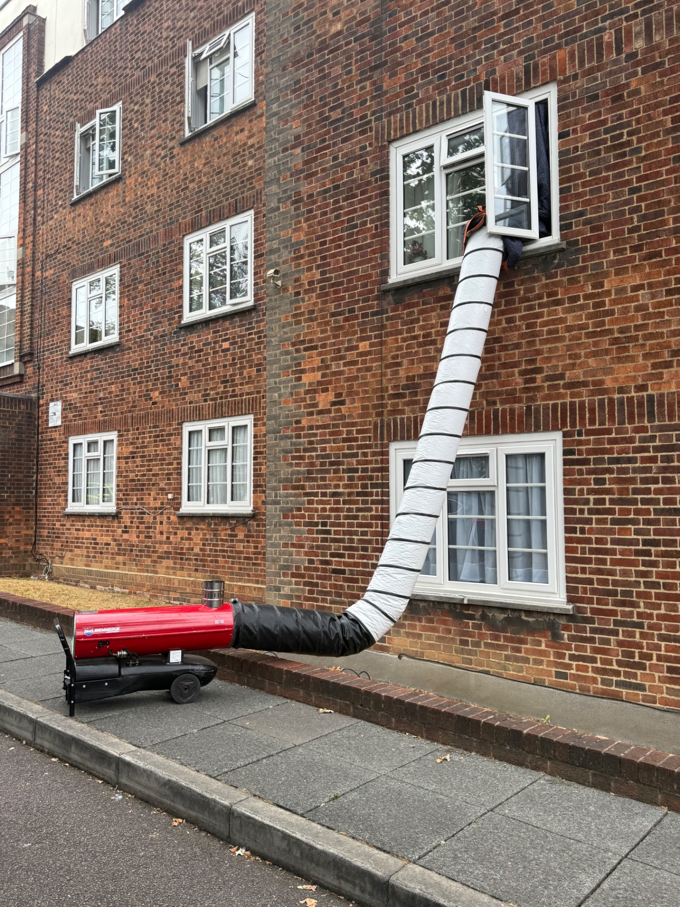 Biemmedue EC32 heater ducted up into a first-floor flat window