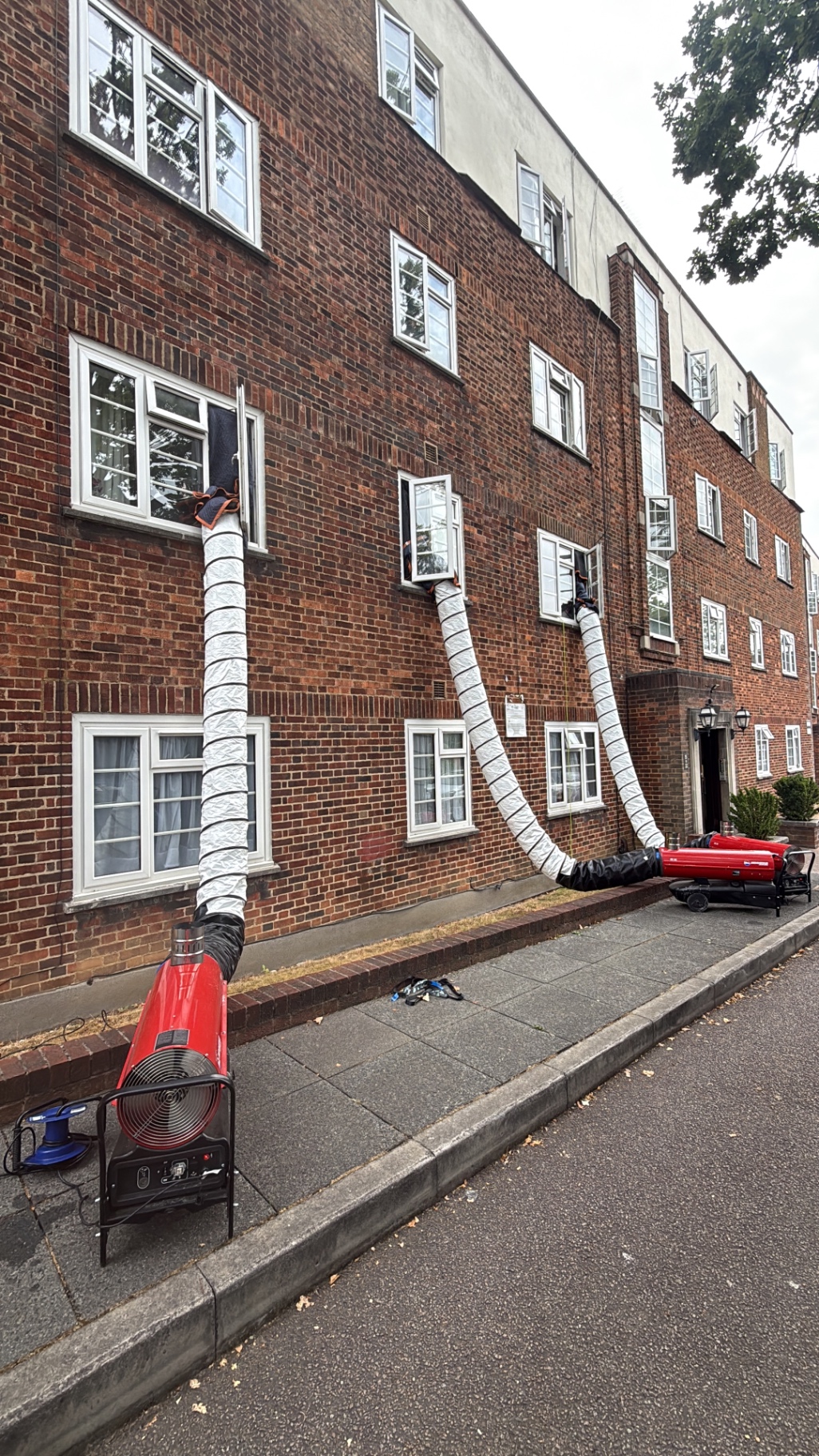 Heat treatment ducting running along a block of flats from the street