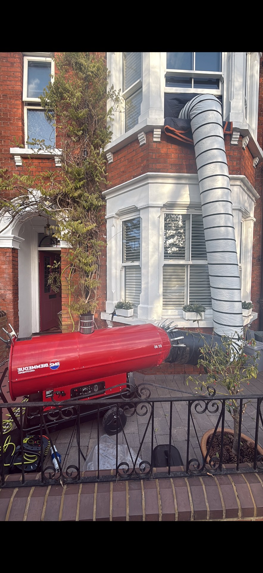 Acrotherm EC85 industrial heater ducting through a window into a bedroom for bedbug heat treatment